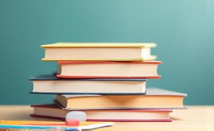 Stack of school textbooks on a desk